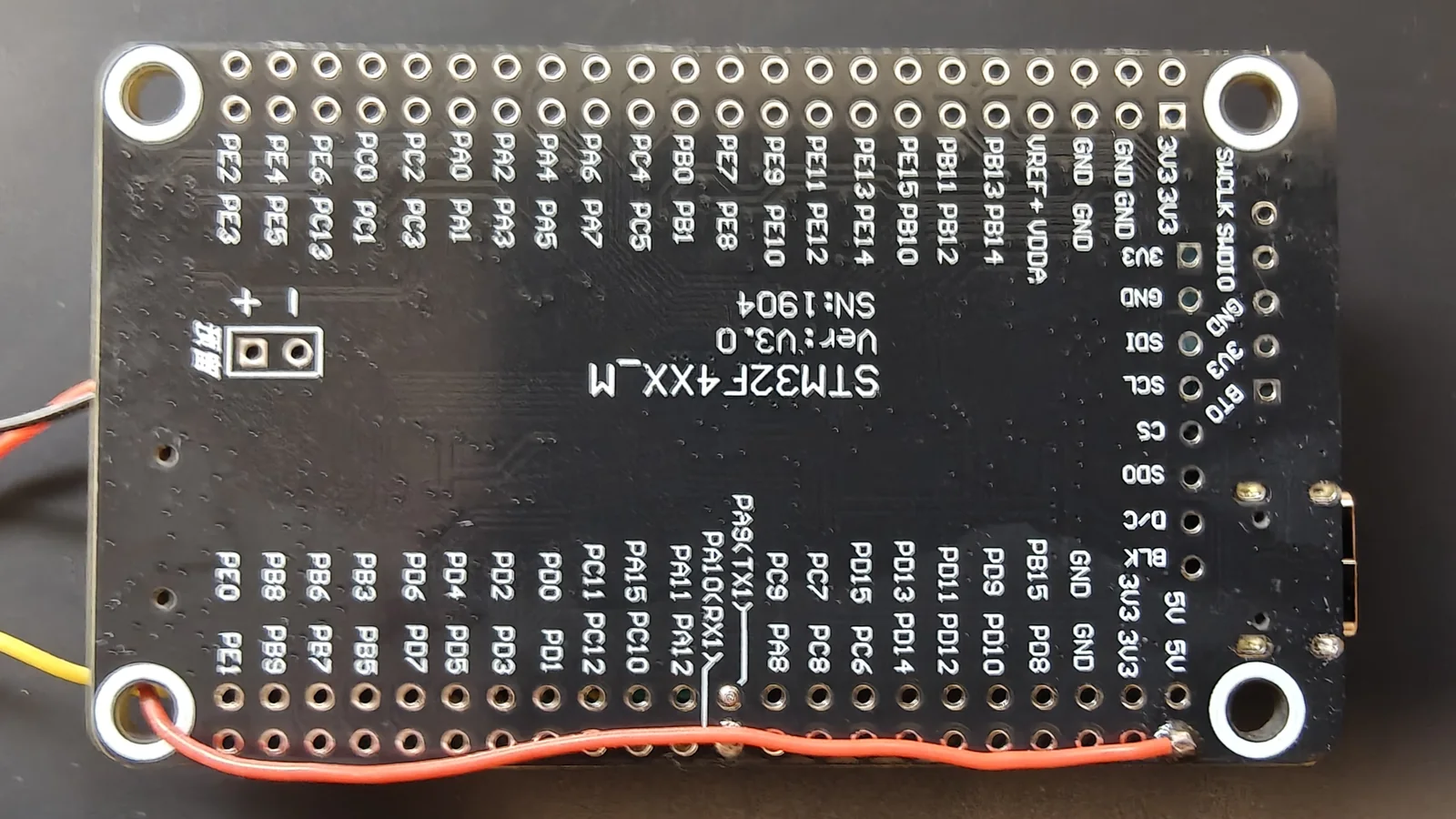 The 5 V wire routed through the board to the underside