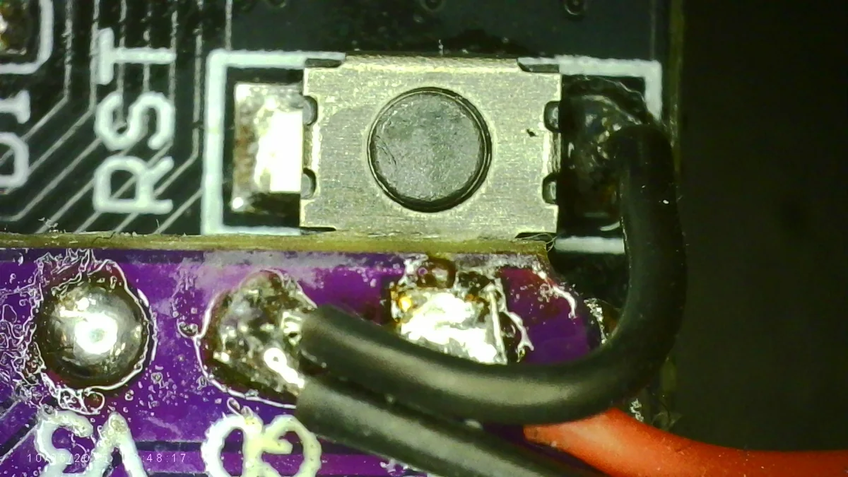 Ground wire soldered to a leg of the RST switch