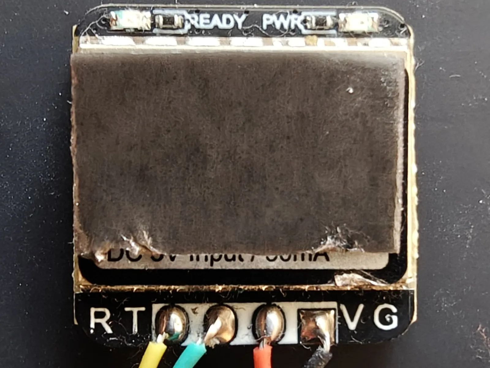A piece of foam tape stuck to the back of the GPS module, beside its R, T, V, G pads