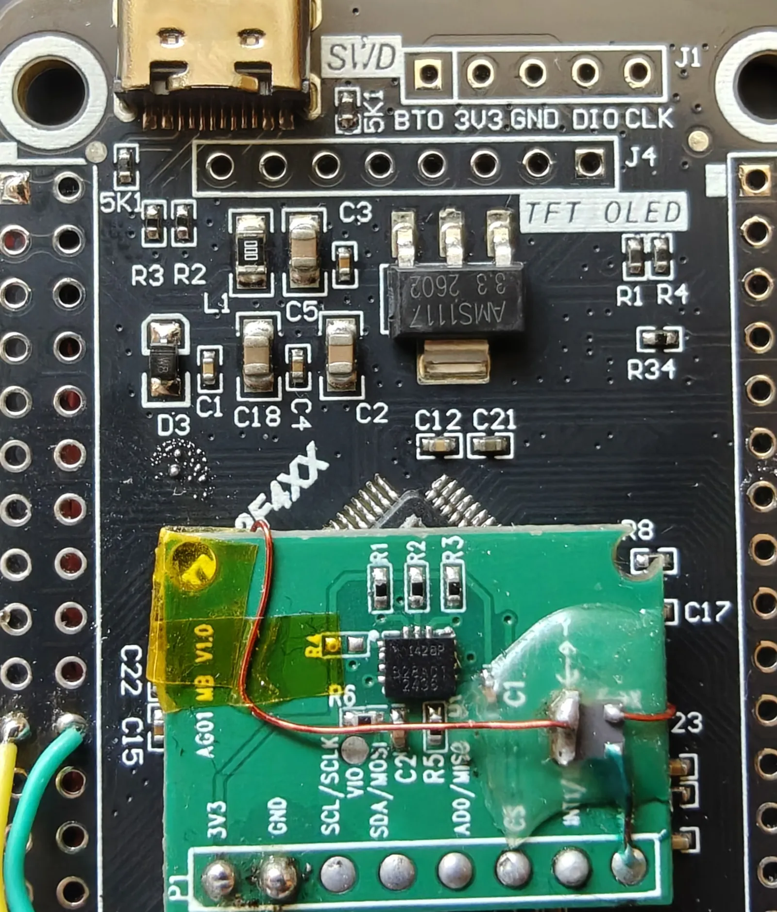 The IMU breakout pressed onto the tape, its Y arrow pointing at the USB-C and SWD end of the board