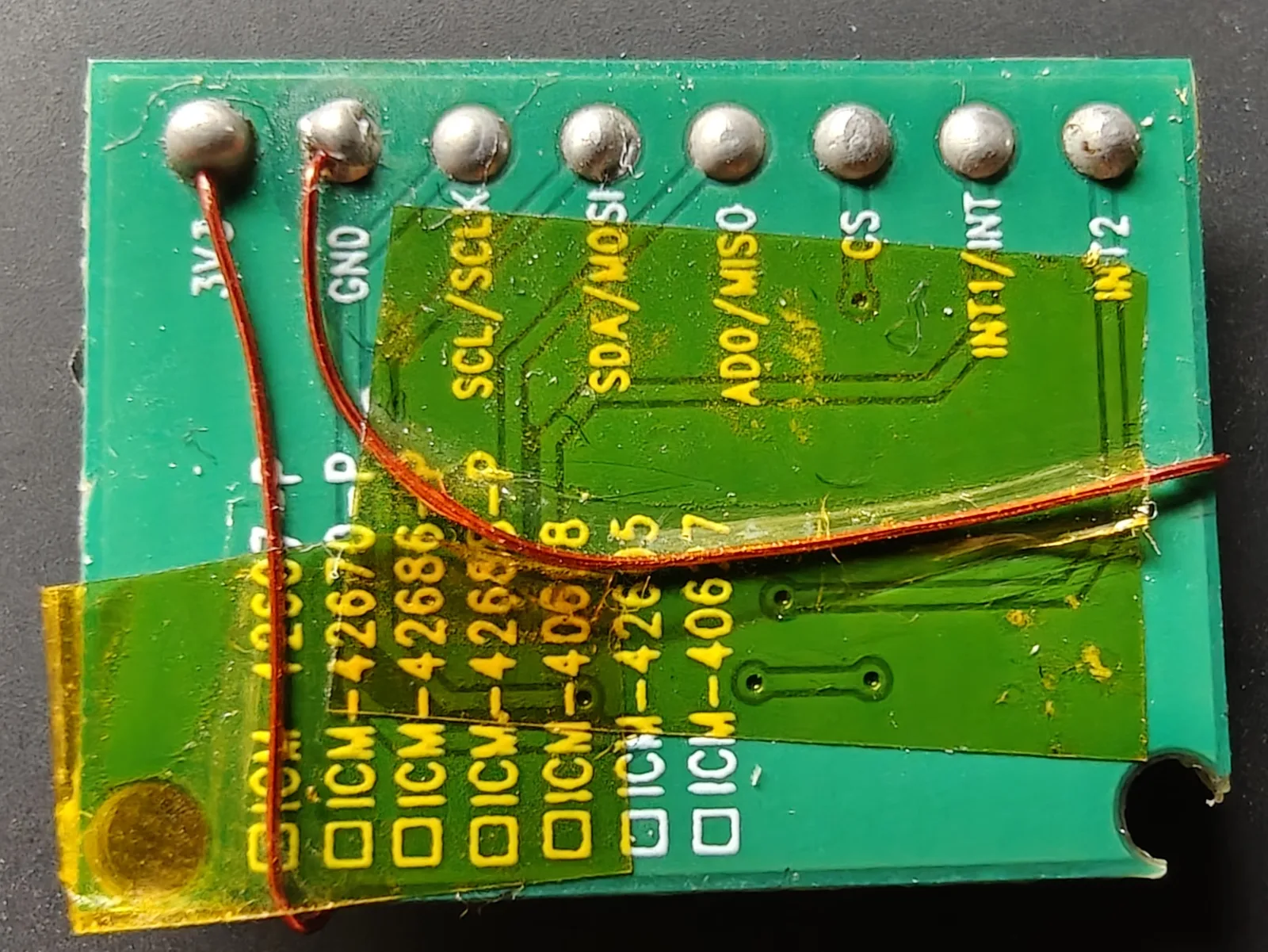 The back of the IMU breakout, with the TCXO's supply wires landing on the 3V3 and GND pads