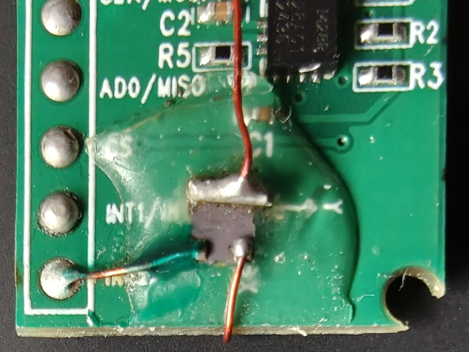 The TCXO glued to the front of the IMU breakout, output wired to the INT2 pad