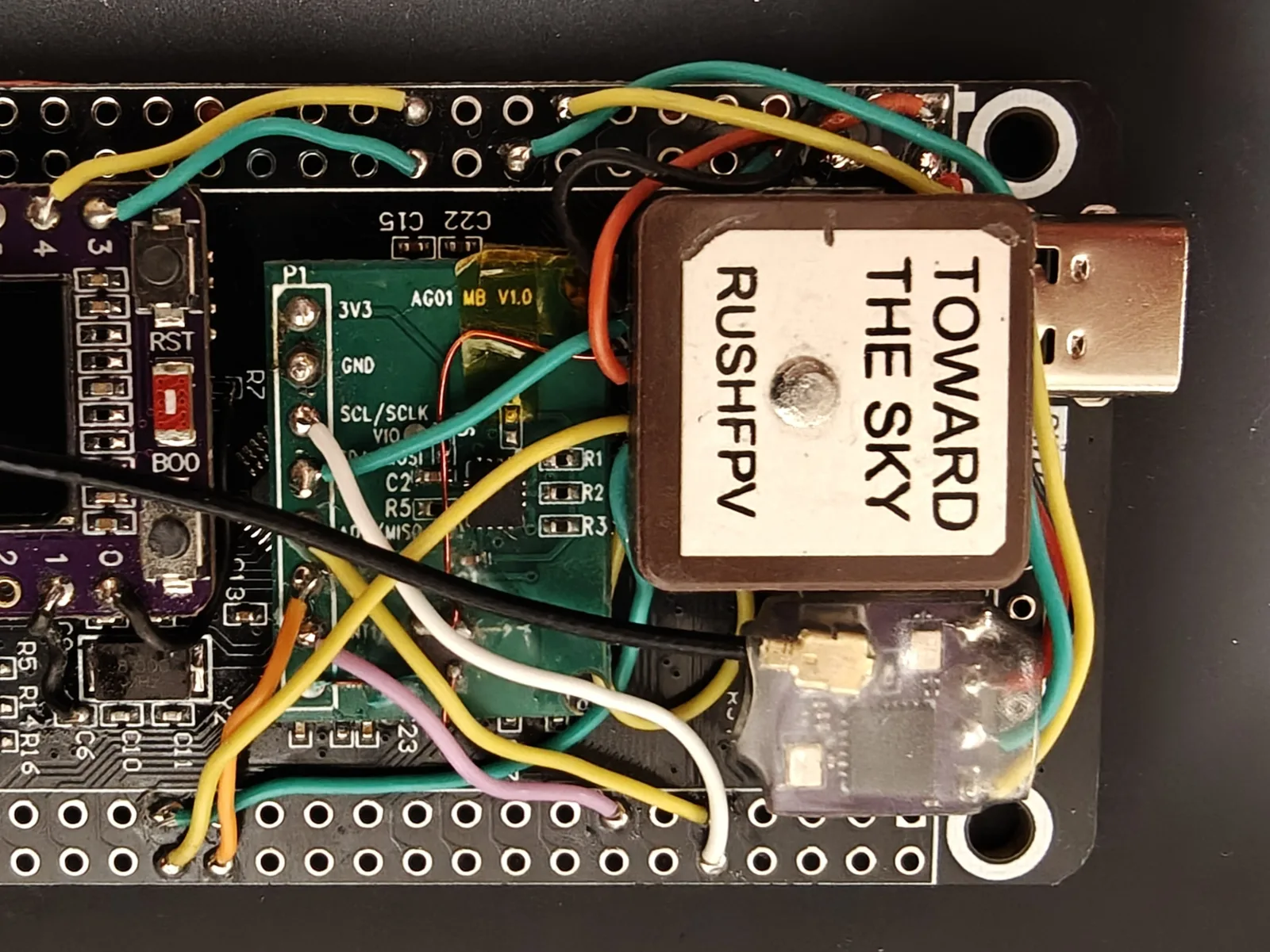 The receiver mounted on the flight computer in the gap beside the GPS